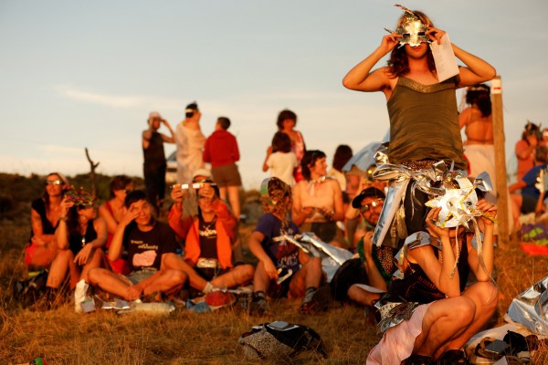 People use self-made artefacts to observe a total solar eclipse near the small village of Castell de Cabres, Spain, August 12, 2026. (REUTERS)