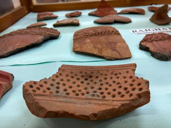 Pieces of carved earthenware vessels and perforated pottery