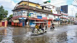 Vehicles wade through a waterlogged area following rainfall, at Hatigaon, in Guwahati, Assam on Sunday, Aug. 9, 2026. (Image: PTI)