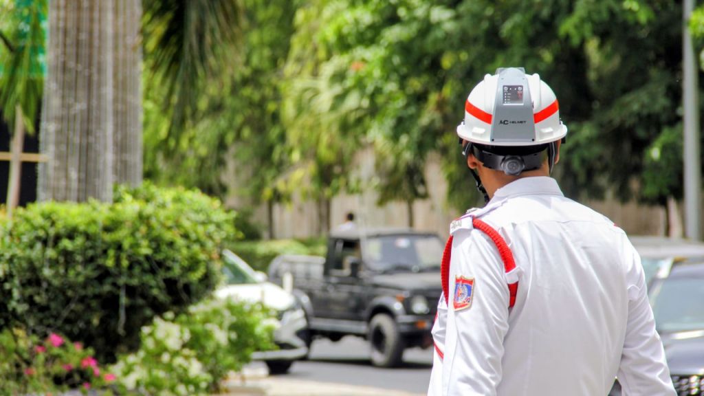 A Delhi Traffic Police personnel wearing an air-conditioned helmet regulates traffic