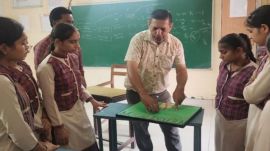 Dinesh Kumar with his students (Express)