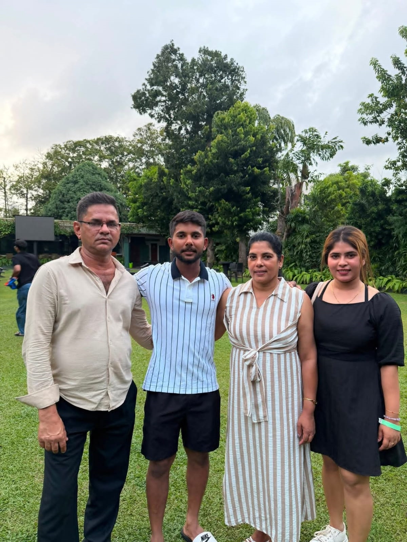 Sonal Dinusha with his parents and sister after the conclusion of Day 5's play on Thursday.