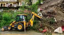 Workers clear debris from a road in Himachal Pradesh after fresh monsoon-triggered landslides. (Express Image)