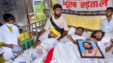 Protesters receive medical attention during an indefinite hunger strike as part of a protest against the Jharkhand government over alleged irregularities in the 14th JPSC examination, JSSC-CGL and other recruitment tests, demanding a CBI probe and reforms in the recruitment agencies, in Ranchi. (PTI Photo)