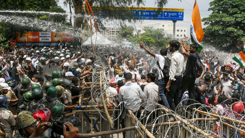 Police personnel deploy water cannons to disperse student protesters and job aspirants attempting to breach barricades during a 'Vidhan Sabha Gherao' protest march towards the Jharkhand Legislative Assembly