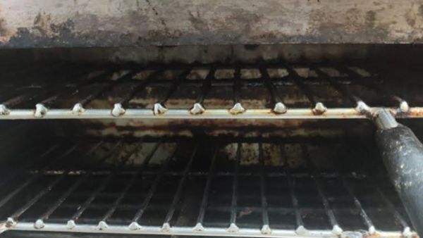 Heavy layers of oil and grease on equipment, rusted metal, and food waste at Status Restaurant. (Photo courtesy - FDA)