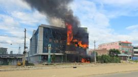 Smoke and fire rise from a mall after it was vandalised following a clash between two communities in Siraha, Nepal, July 30, 2026. Picture taken with a mobile phone. REUTERS