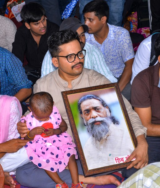 A man holds a portrait of Jharkhand Mukti Morcha (JMM) founder late Shibu Soren during an indefinite protest against the Jharkhand Government