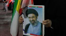 An Iranian pro-government demonstrator holds a poster of the Supreme Leader Ayatollah Mojtaba Khamenei in a gathering at a square in Tehran, Iran (AP Photo)