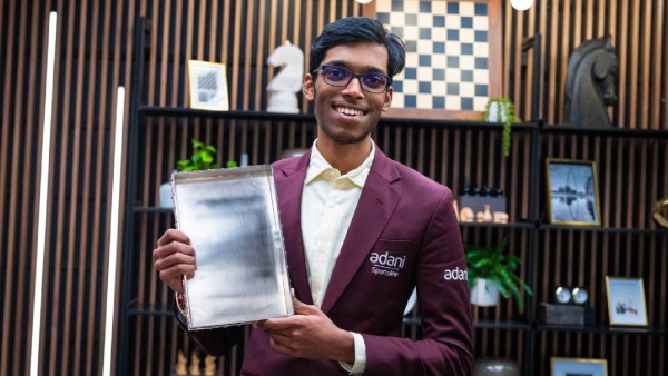 Praggnanandhaa poses with the 2026 GCT Finals trophy. (Lennart Ootes/Grand Chess Tour)