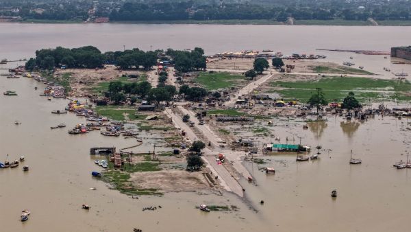 An aerial view shows the submerged low-lying areas, access roads, and boats anchored at Sangam. (PTI Photo)