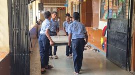 tudents shift an inoperative smart board through a school corridor. (Shubham Kurale)