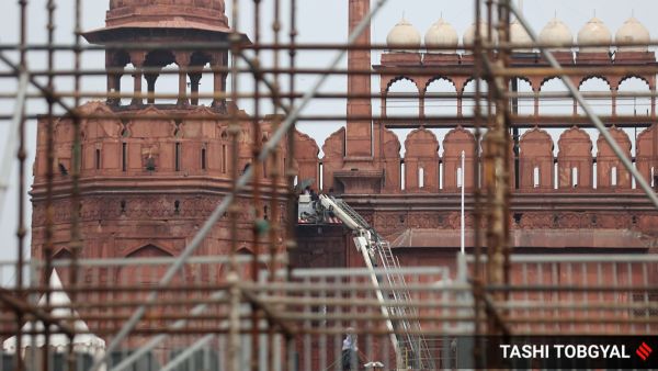 Workers are seen making preparations for the forthcoiming Independence day celebrations at the Red fort in Delhi on Wednesday. Express Photo by Tashi Tobgyal