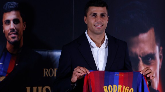 Barcelona's Rodri poses with his jersey during his official presentation at a soccer press conference in Barcelona, Spain, Tuesday, Aug. 18, 2026. (AP Photo/Joan Monfort)