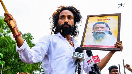 Jharkhand Student leader Devendra Nath Mahto holds the portrait of Padma Bhushan awardee and former state CM late Shibu Soren during the 'Vidhan Sabha gherao' march, in Ranchi on Monday. He has been on a hunger strike at Jaipal Singh Munda Stadium, the main protest site, for the past 9 days. (ANI Video Grab)