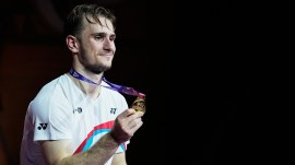 France's Alex Lanier poses for a photograph with his gold medal after winning against Japan's Kodai Naraoka in the men's singles final match of the Badminton World Championships in New Delhi, India, Sunday, Aug. 23, 2026. (AP Photo/Manish Swarup)