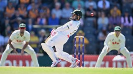 Bangladesh's Mushfiqur Rahim, center, evades a ball from Australian bowler Pat Cummins during the second day of their second cricket Test match in Mackay. (AAP Image via AP)
