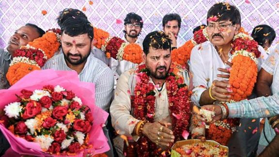 Supporters congratulate former Wrestling Federation of India (WFI) chief Brij Bhushan Sharan Singh with floral garlands and sweets after he was acquitted by the Rouse Avenue Court in the alleged sexual harassment case involving women wrestlers, in New Delhi on Monday. (ANI Photo)