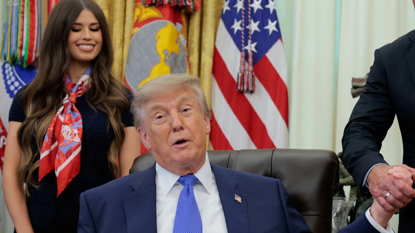 Trump 'Zapper' mystery: Why the woman behind him kept touching her stomach