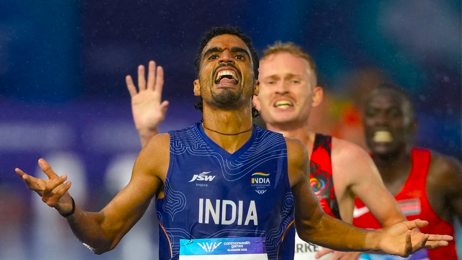 Gulveer Singh, of India, crosses the finish line to win the silver medal in the men's 10,000 meters final at the Commonwealth Games in Glasgow. (AP Photo)