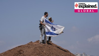 Israeli settlers put up a flag after it was taken down by peace activists in support of local landowners whose property is threatened with seizure by settlers, on the outskirts of the West Bank city of Beit Sahour, Aug. 14.