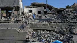 A man checks a destroyed home that was hit by an Israeli airstrike in Ansar village, southern Lebanon, Saturday. (AP Photo)