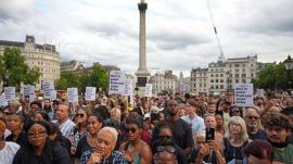 People attend a vigil held by Stand Up to Racism in memory of late University of Cambridge professor Jason Arday at Trafalgar Square in London. (AP Photo/Kirsty Wigglesworth)
