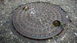 An old manhole-cover is seen, at Bandra West in Mumbai on 25 July 2026. (Express Photo by Sankhadeep Banerjee)