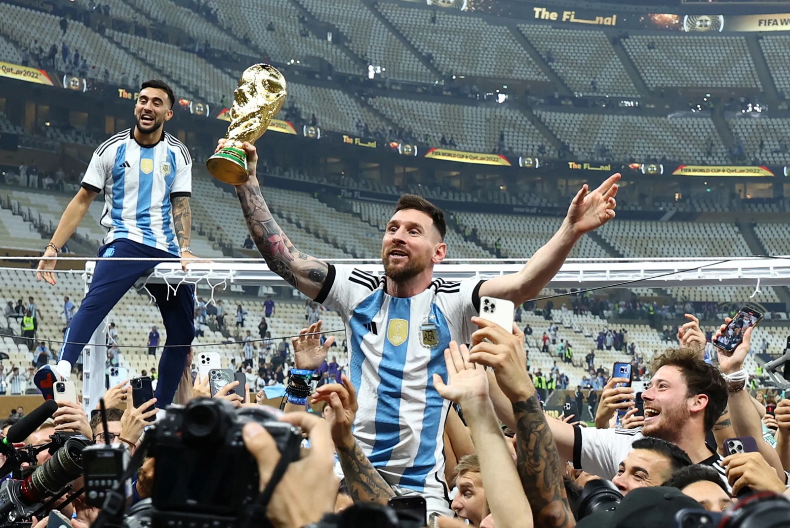 Argentina's Lionel Messi celebrates with the trophy after winning the World Cup. REUTERS/Kai Pfaffenbach