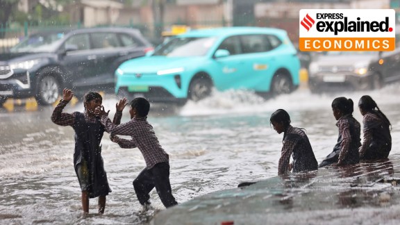 School children enjoy themselves in the rain during the heavy showers in the capital New Delhi.