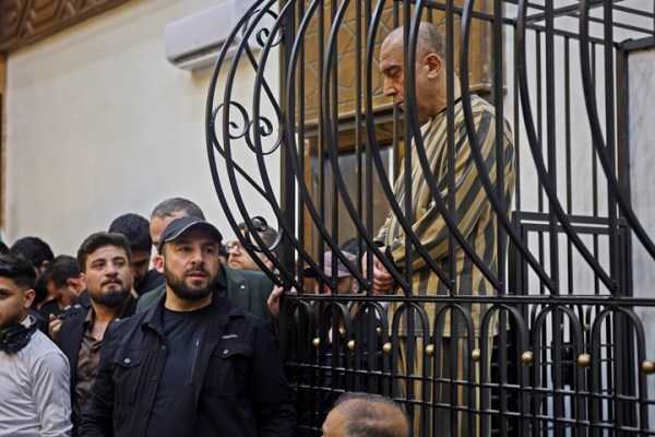 Atef Najib, former head of the Political Security Branch in the Daraa area during Bashar Assad's rule, sits in the defendants' cage during a trial session at the Palace of Justice in Damascus, Syria, April 26, 2026. 