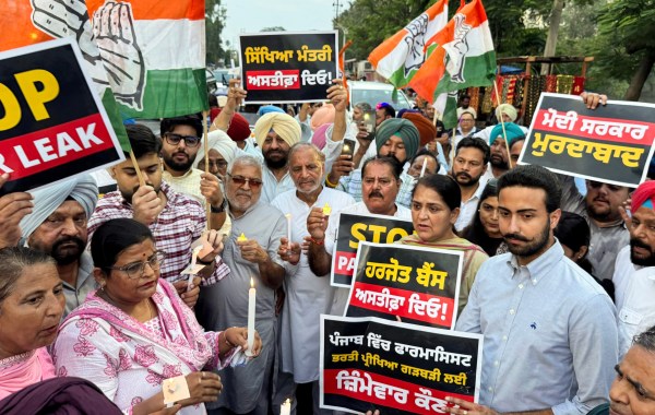Congress MP Dharamvira Gandhi, with party leaders and workers, stages a protest against the Punjab Government over the alleged question paper leak at Baba Farid University, demanding a high-level probe and the resignation of Punjab Education Minister Harjit Singh, in Patiala on Monday. (ANI Photo)