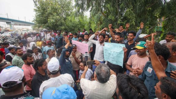 Sanitation workers protest next to National Highway 24 in Delhi on Tuesday after their colleague was stabbed to death.