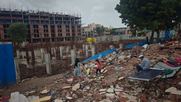 People amid the debris of demolished structures at Nasirnagar in Surat, where 106 units were razed on May 30. (Express Photo)