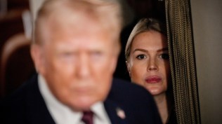 White House press secretary Karoline Leavitt watches as President Donald Trump speaks to reporters while in flight on Air Force One to Joint Base Andrews. (AP file)