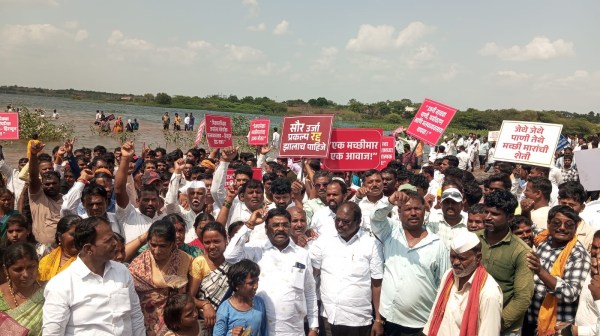 Fishermen wade into the Ujani reservoir during the protest at Palasdev on Monday. (Express)