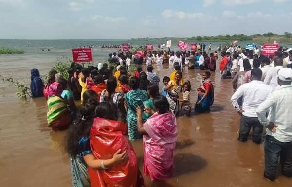 Fishermen wade into the Ujani reservoir during the protest at Palasdev on Monday. (Express)