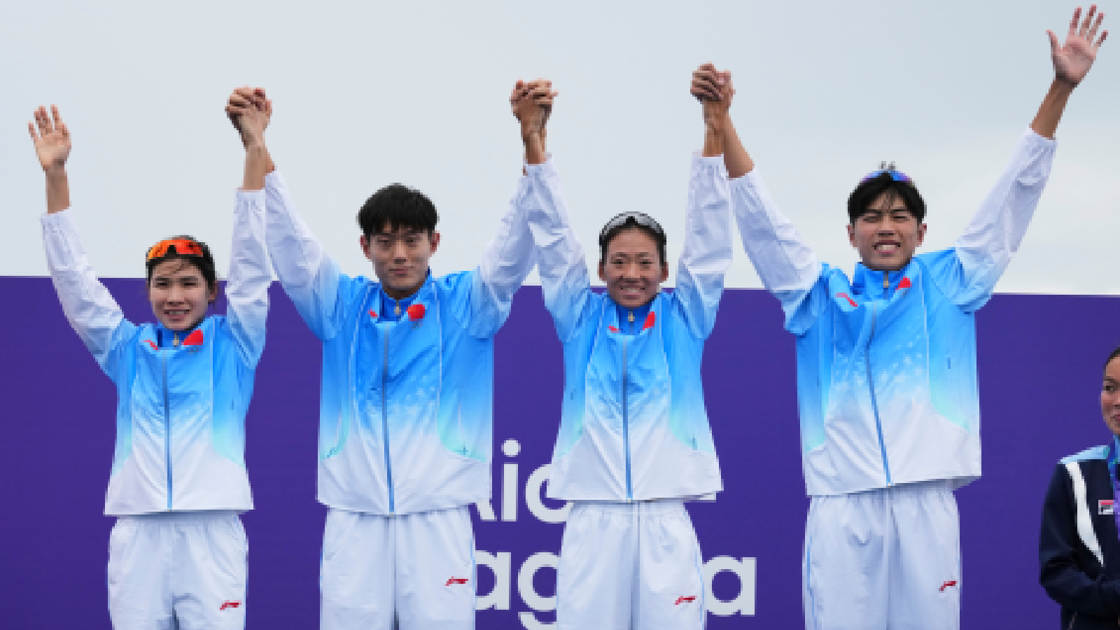 China's mixed relay triathlon gold medalists from left, Lin Xinyu, Li Mingxu, Huang Anqi and Zhang Xirui react on the podium at the Asian Games in Gamagori, Japan, Monday, Sept. 21, 2026.