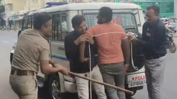 Gujarat murder accused tied with ropes by police, Gujarat murder accused flogged in public by police, Gujarat Police, Ahmedabad police, Indian express news, current affairs