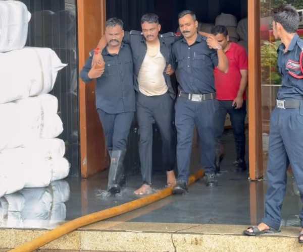 An injured fireman Praveen Patel seen taken out from Shyam Sangini Textile market. (Express Photo by Hanif Malek)