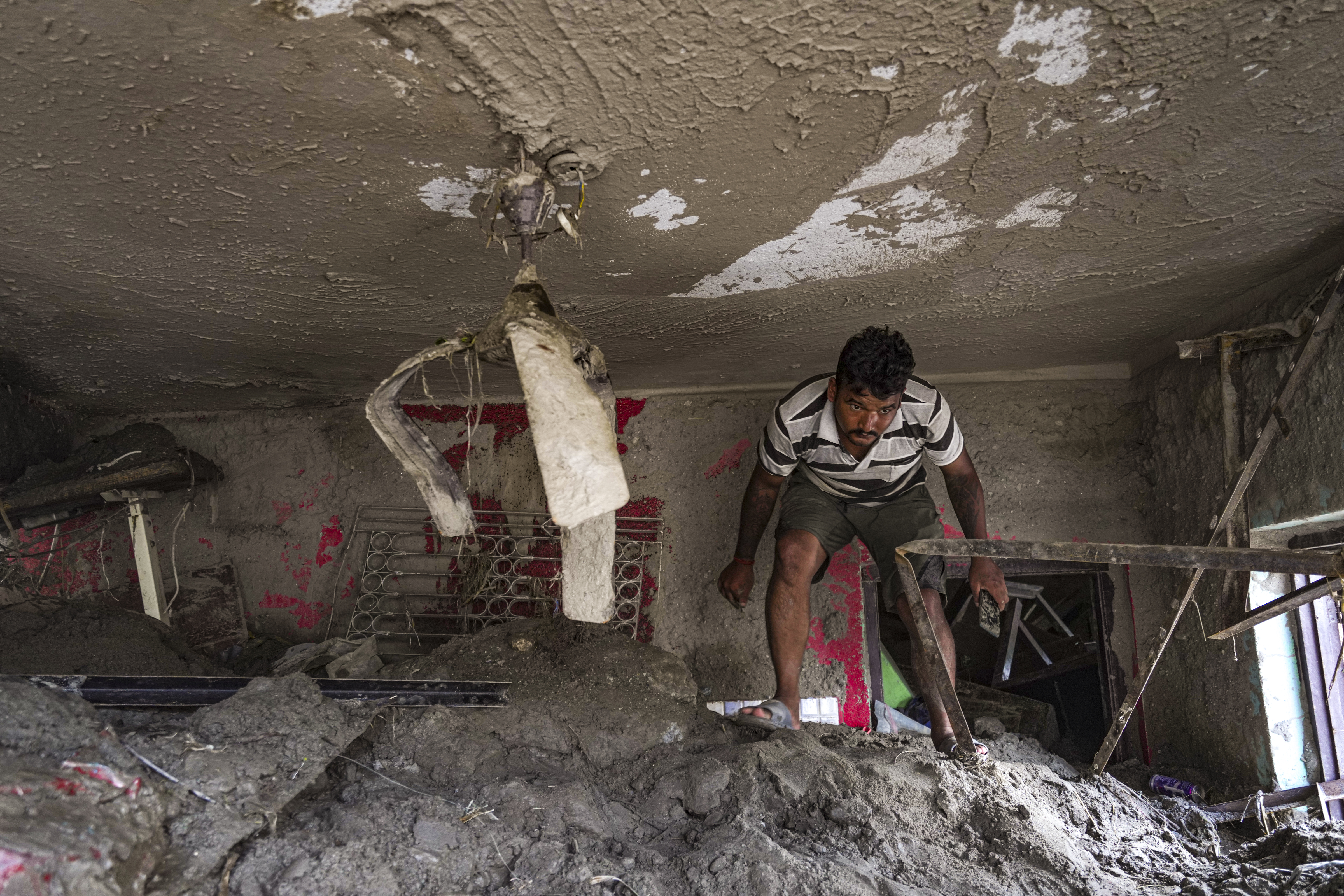 Devighat: A man clears mud and debris in the aftermath of devastating flash floods, at Devighat, in Nuwakot district, Nepal, Monday, Aug. 31, 2026. The death toll from flash floods in Nepal rose to 903 on Monday, with bodies continuing to be recovered, while 4,247 people are still missing following the disaster, authorities said. (PTI Photo)