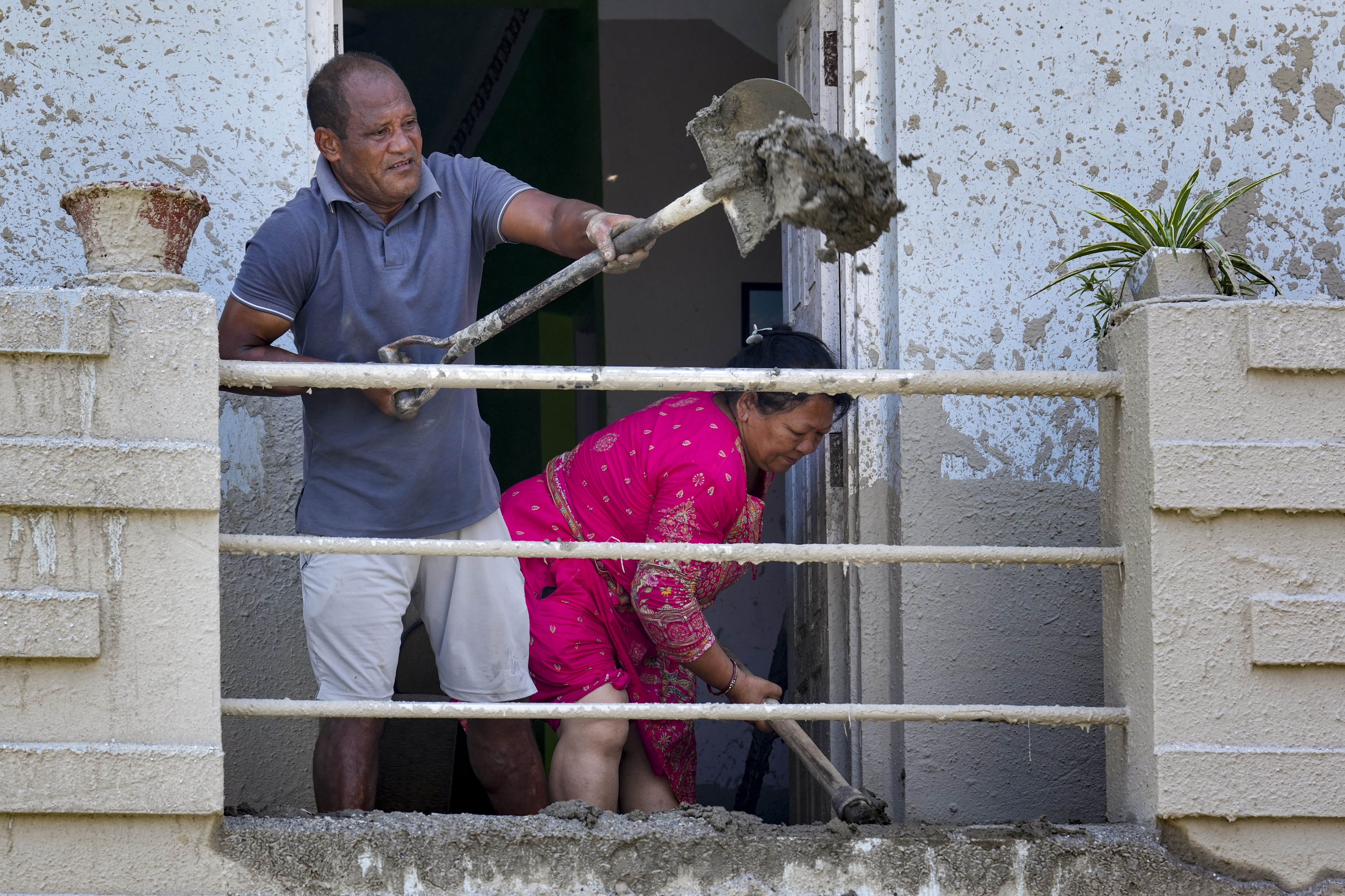 Devighat: People clear mud and debris in the aftermath of devastating flash floods, at Devighat, in Nuwakot district, Nepal, Monday, Aug. 31, 2026. The death toll from flash floods in Nepal rose to 903 on Monday, with bodies continuing to be recovered, while 4,247 people are still missing following the disaster, authorities said. (PTI Photo)