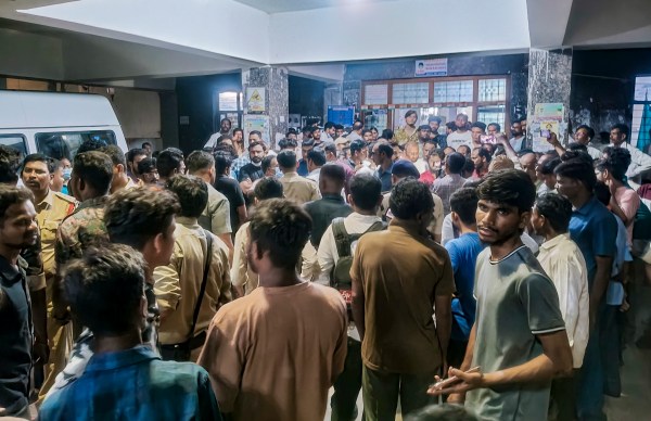 People gather after the Special Newborn Care Unit (SNCU) of the state-run RIMS caught fire after the AC unit burst, in Adilabad, Telangana, Tuesday, Sept. 22, 2026. Two infants died, and two other babies are in critical condition after the incident. (PTI Photo)
