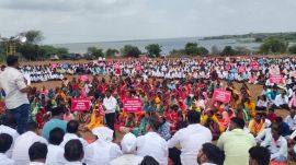 Fishermen wade into the Ujani reservoir during the protest at Palasdev on Monday. (Express)