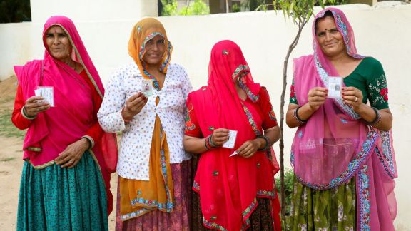 Rajasthan: A group of women show their Voter ID cards as the re-poll was conducted at the polling station at a polling booth in Ward 62, in Jaipur on Sunday. (ANI Photo)
