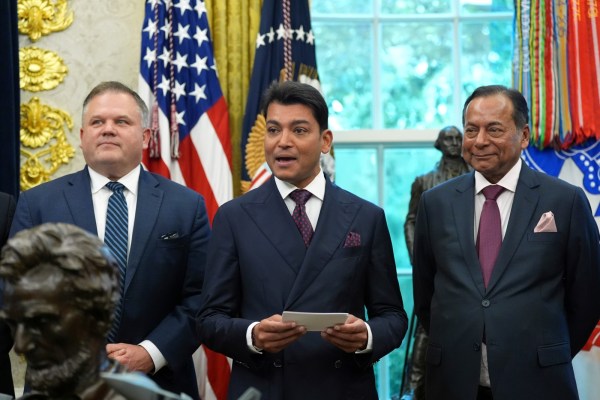 Mesabi Metallics Chairman Rewant Ruia speaks as Essar Capital Director Prashant Ruia, right, and Mesabi Metallics CEO Joe Broking listen during an event with President Donald Trump in the Oval Office of the White House.