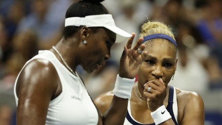 Venus Williams, left, and Serena Williams, of the United States, confer as they play against Hao-Ching Chan, of Taiwan, and Maya Joint, of Australia, during a women's doubles match at the U.S. Open tennis championships. (AP Photo)