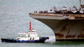 A tug boat greets the US Navy aircraft carrier USS Abraham Lincoln as it arrives at the port in Laem Chabang, Chonburi, Thailand, Wednesday, Sept. 2, 2026. (AP)