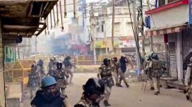 Security personnel disperse tear gas shells following stone-pelting incidents during protests against the proposed removal of a portion of the 'Shahi Masjid' for road widening, in Ujjain, Madhya Pradesh, Monday, Sept. 28, 2026. (PTI Photo)