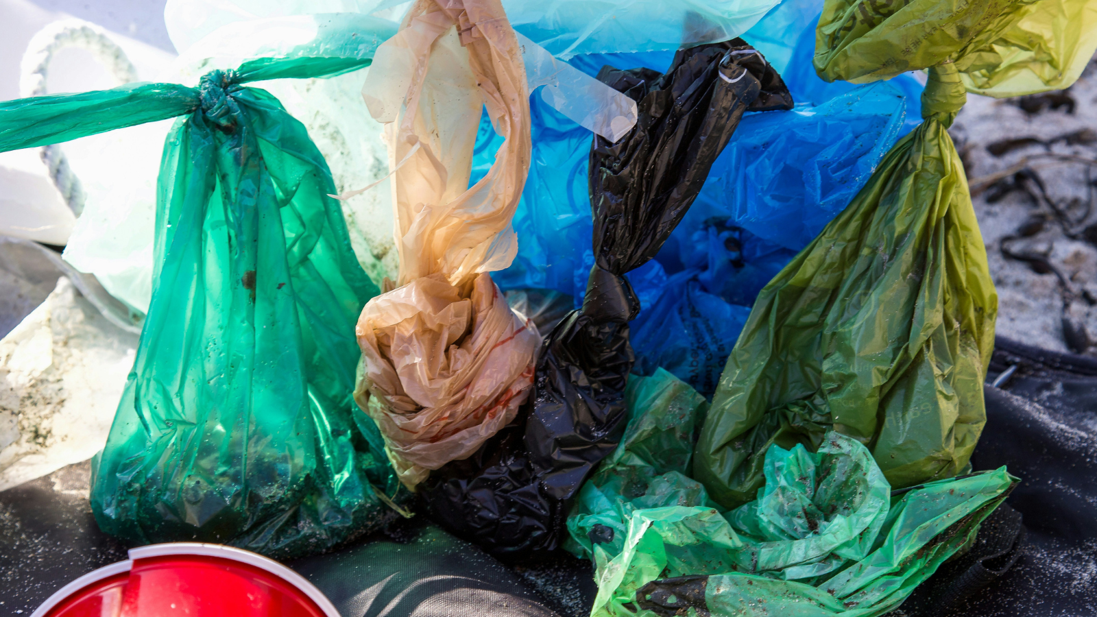 Different types of packaging used for quick-commerce deliveries including plastic bags and protective wrapping